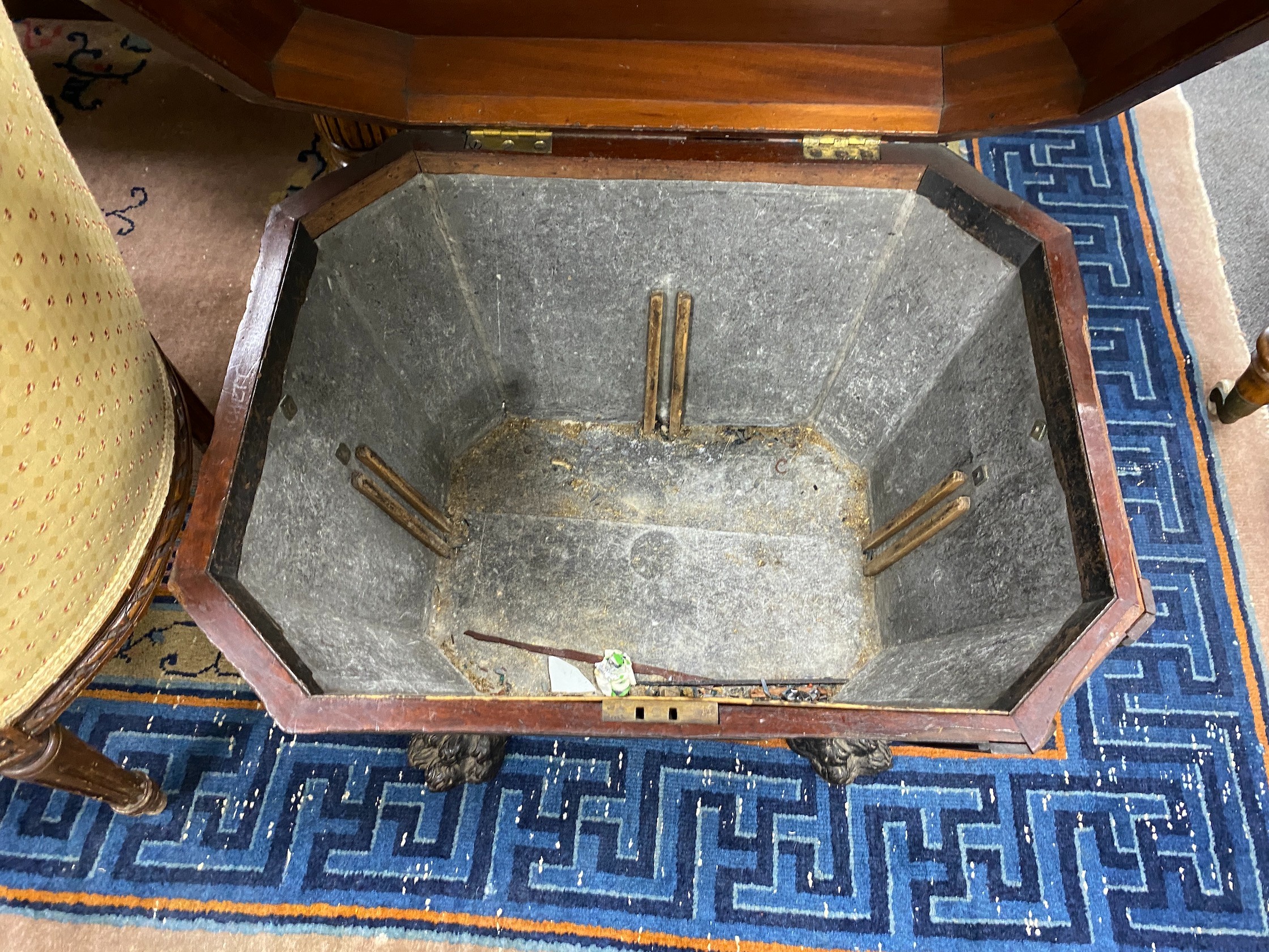 A Regency and later mahogany sarcophagus wine cooler on cast metal lions paw feet, width 56cm, depth 45cm, height 50cm.
